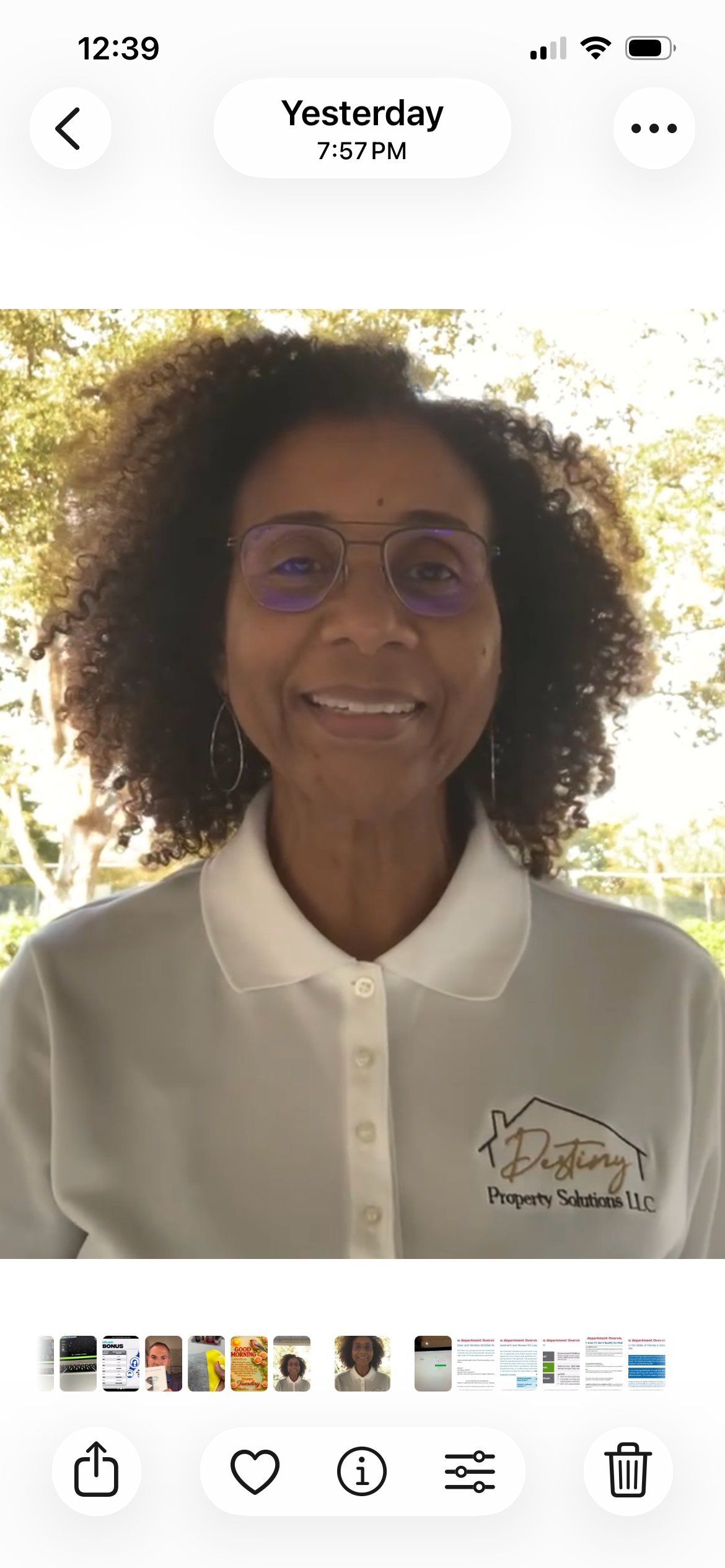 Andrea Matthews, founder of Destiny Property Solutions, smiling outdoors wearing a white polo with the company logo